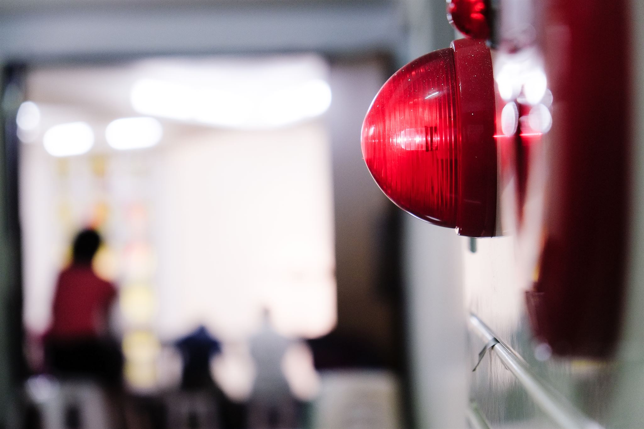 Red-alarm-light-with-people-on-the-background